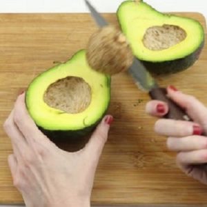 Cut the avocados in half and remove the pits Cut the avocados in half and remove the pits