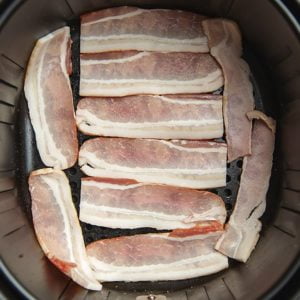 Lay bacon inside air fryer basket in a single layer.