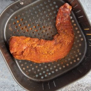 Put the pork tenderloin into the basket of the air fryer. If it doesn’t fit while straight, bend it a bit to fit it in. Put the pork tenderloin into the basket of the air fryer. If it doesn’t fit while straight, bend it a bit to fit it in.