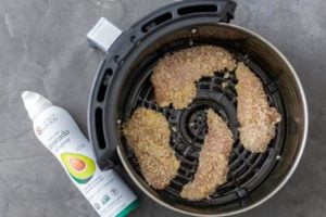 Spray both sides of the chicken generously with avocado or olive oil.