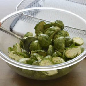Use a large mixing bowl to toss your Brussels sprouts with olive oil, salt Use a large mixing bowl to toss your Brussels sprouts with olive oil, salt